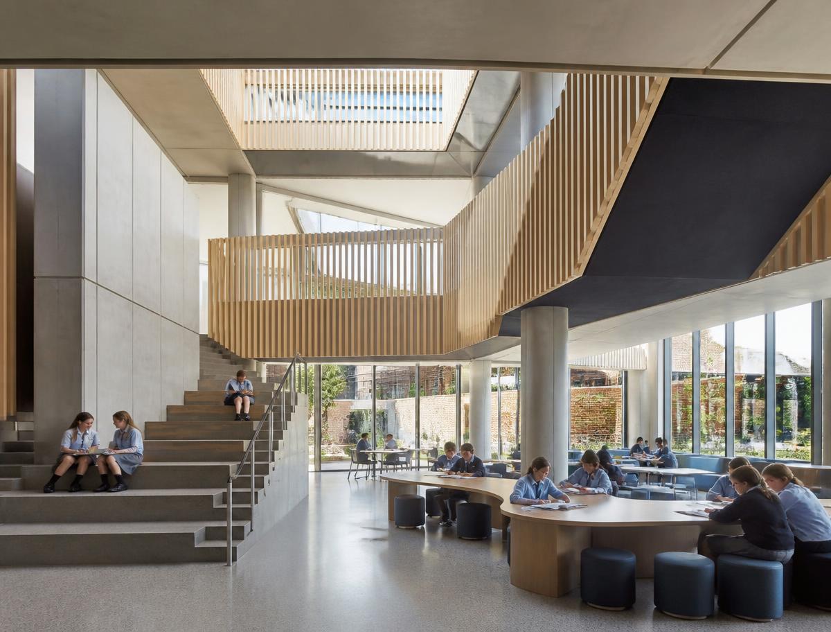 Students in a bright, modern school atrium